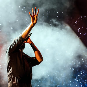 Mammoth Production artist agent, illustrated by a music artist performing holding his arm forward towards audience